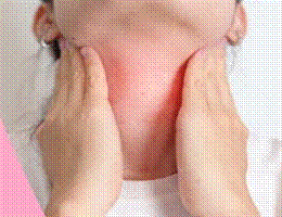 Person cupping the front of their neck with both hands, suggesting throat discomfort or pain.