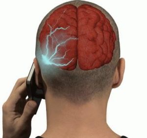 Back view of a person talking on a cellphone; a red brain illustration with blue electrical activity appears on the left side of the head.
